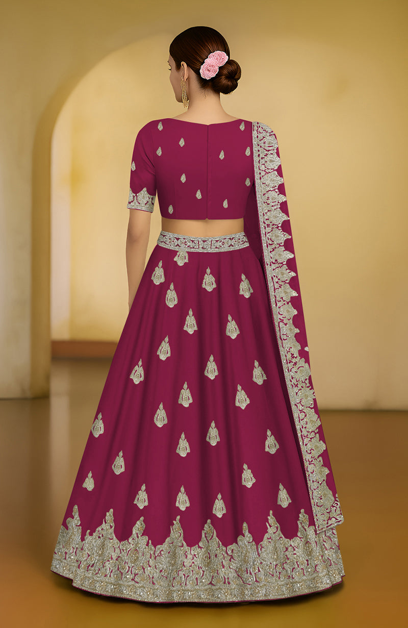 Bright rose lehenga set with intricate tilla and zardozi embroidery, V-neck blouse, and dupatta.