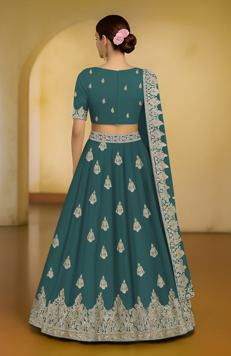 A green peacock lehenga set featuring intricate tilla and zardozi embroidery with a flared silhouette.