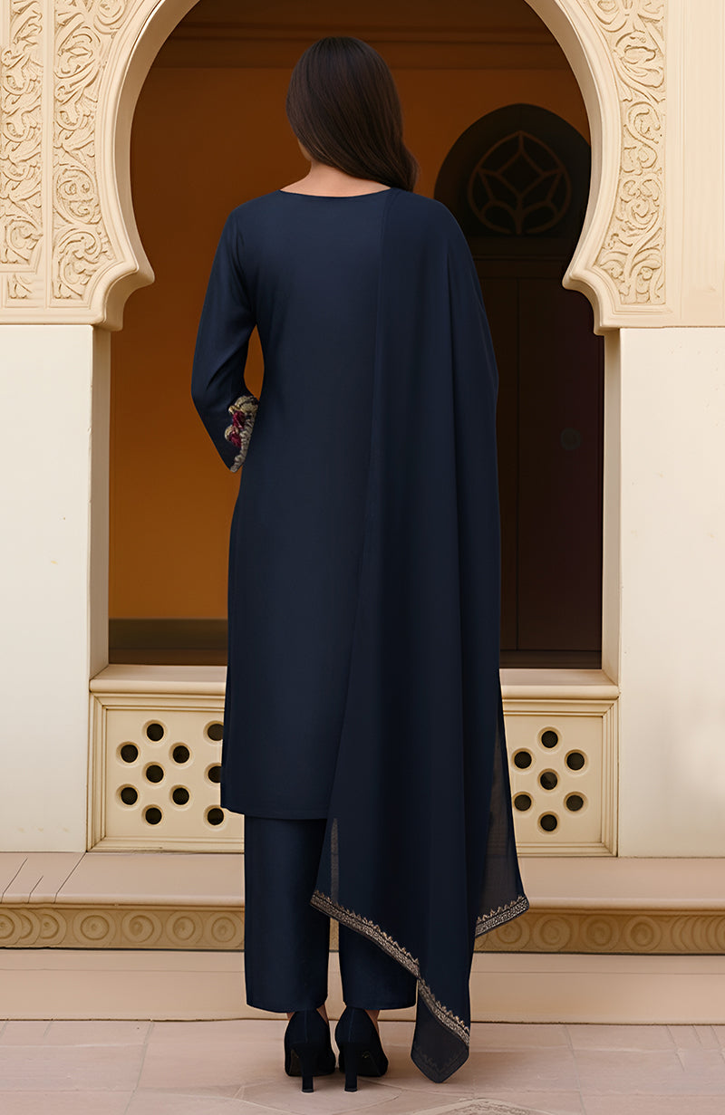 Navy blue kurta set with floral gold and burgundy embroidery and matching straight pants.