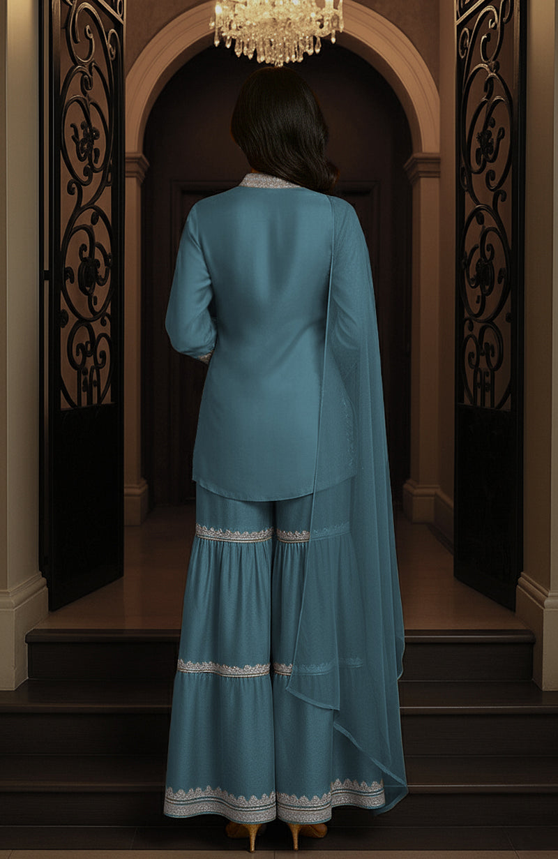 Peacock blue gharara set with embroidered tunic, wide-legged pants, and matching draped piece.