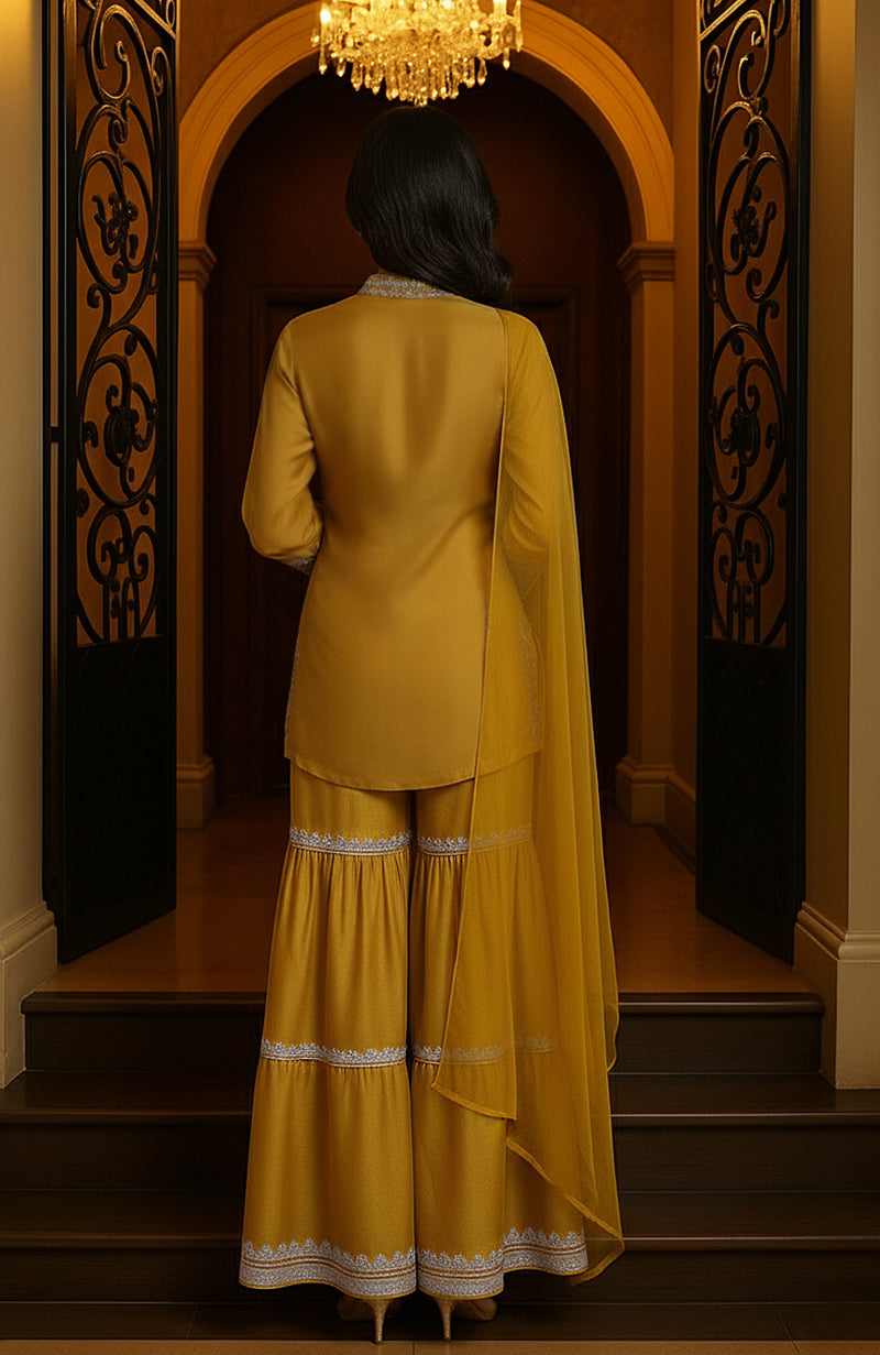 Mustard yellow embroidered gharara set with V-neck tunic, full sleeves, and tiered wide-legged pants