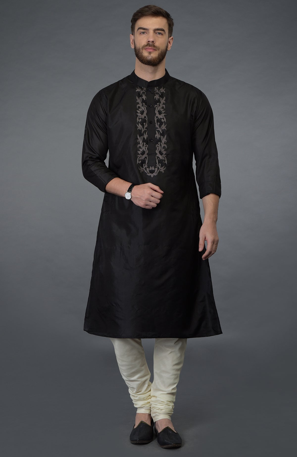 Black silk kurta with floral embroidered placket and cream churidar.