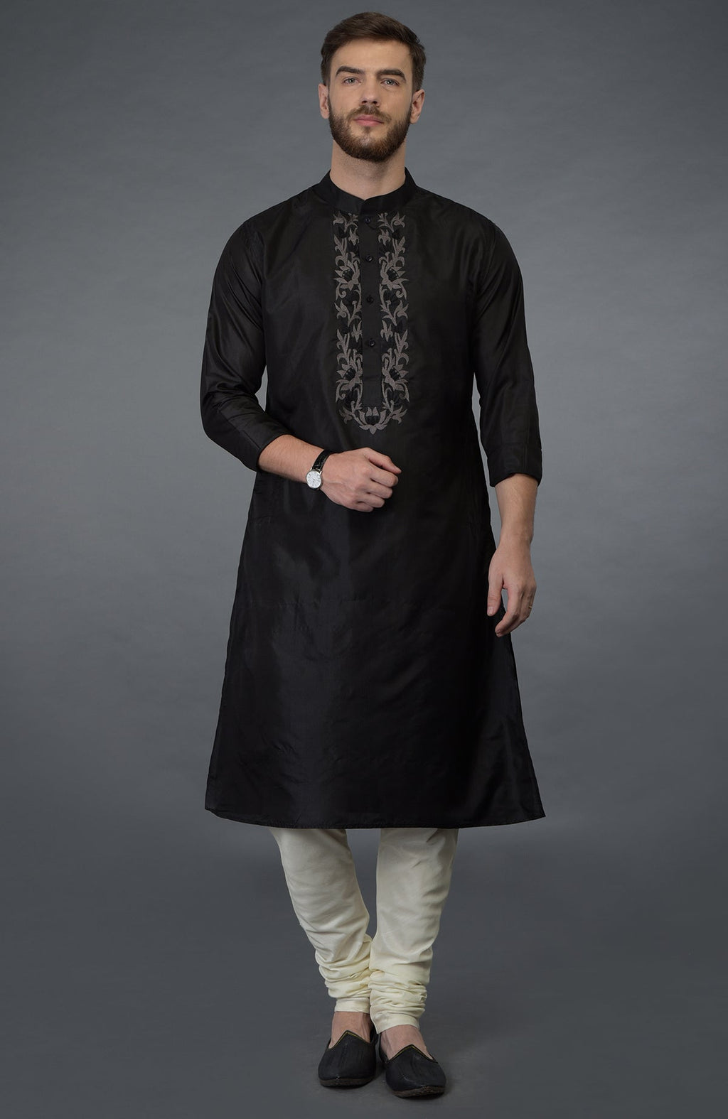 Black silk kurta with floral embroidered placket and cream churidar.