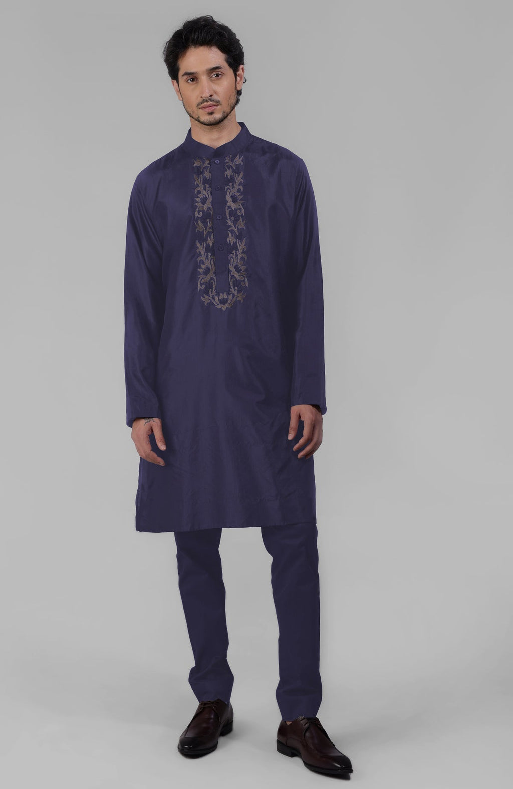 A man models a wine silk kurta with floral embroidered placket detail.