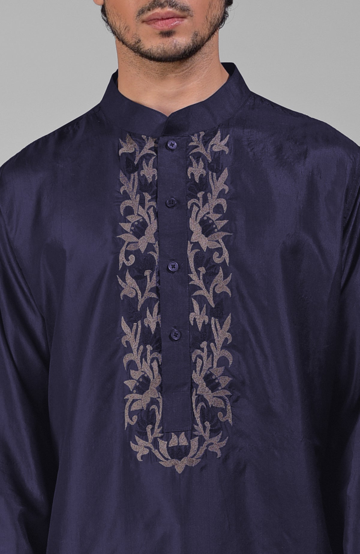 Ink blue silk kurta with floral embroidered placket detail.