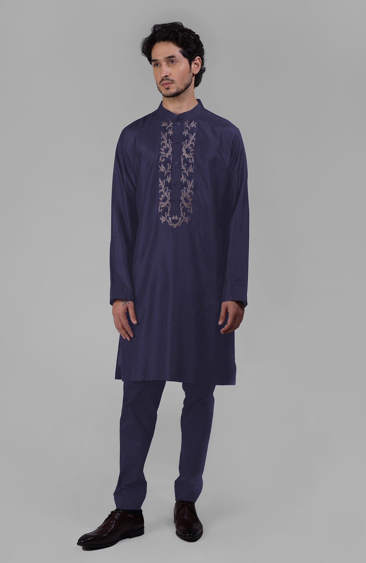 Ink blue silk kurta with floral embroidered placket detail.