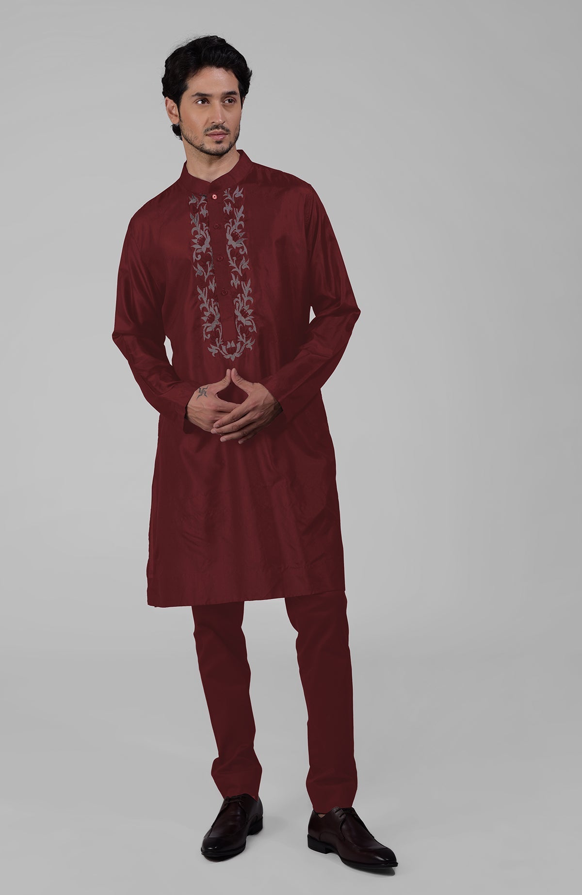Maroon silk kurta with floral embroidered placket detail.