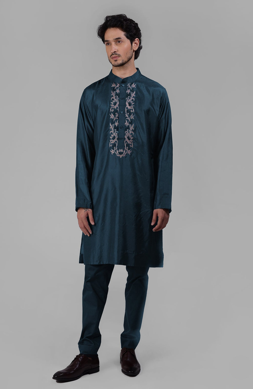 Teal silk kurta with floral embroidered placket detail.