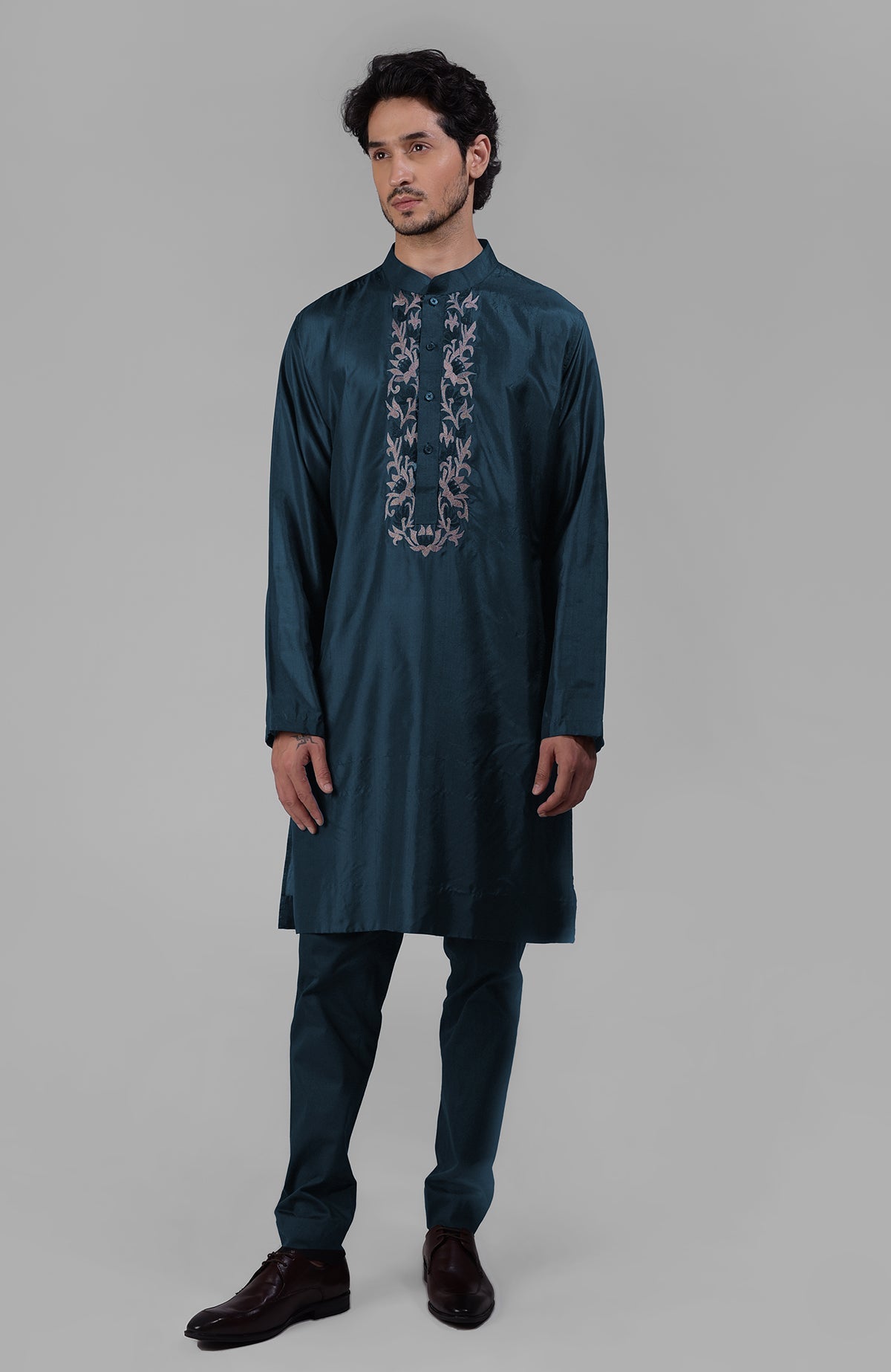 Teal silk kurta with floral embroidered placket detail.