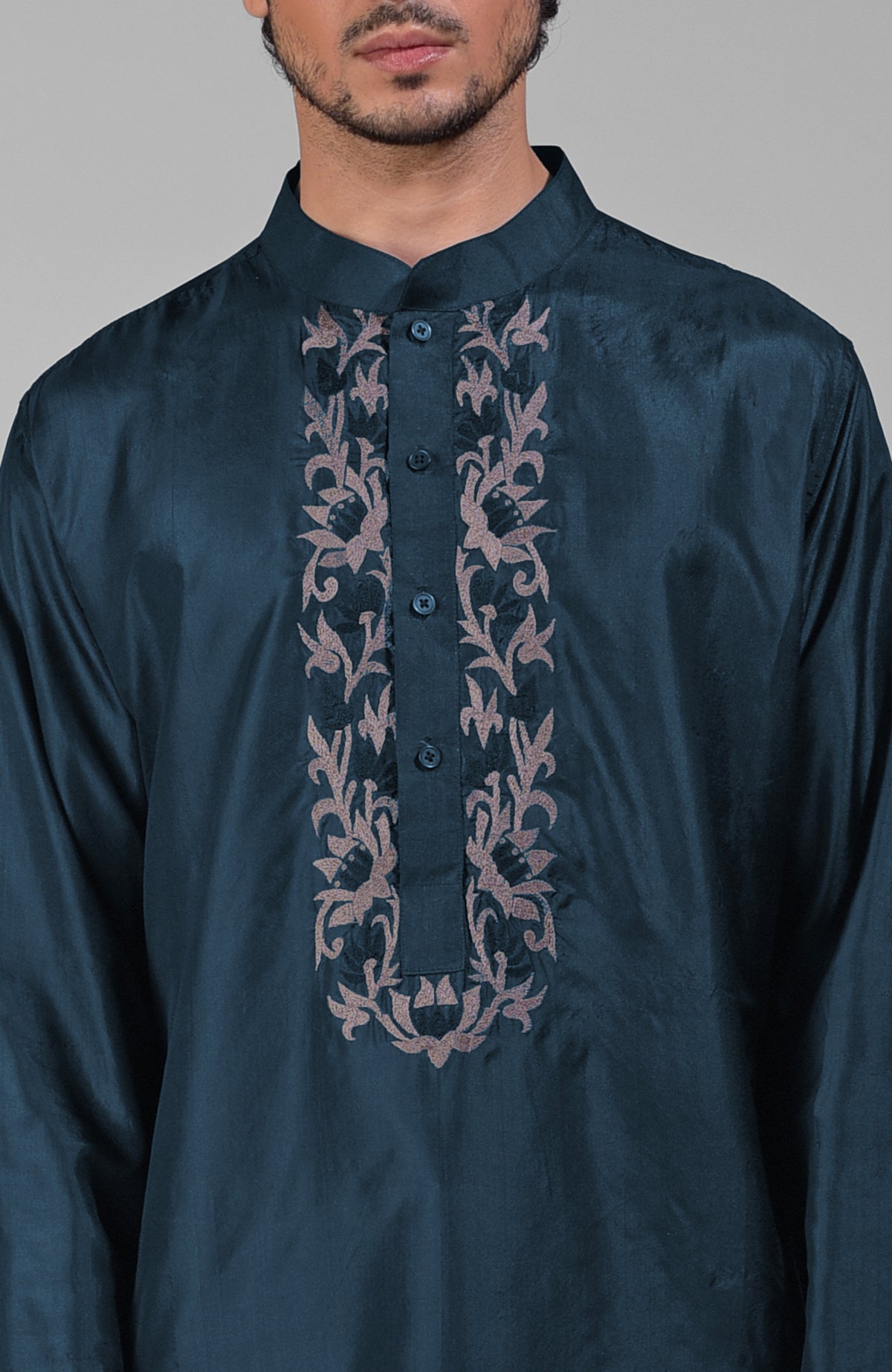 Teal silk kurta with floral embroidered placket detail.