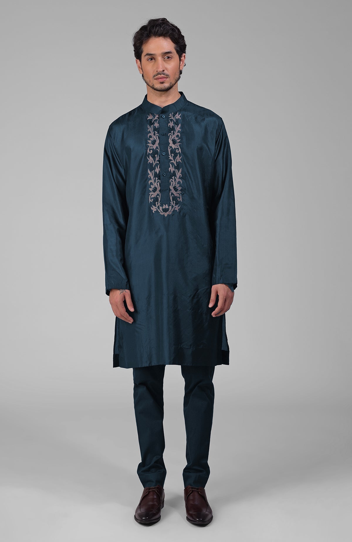 Teal silk kurta with floral embroidered placket detail.