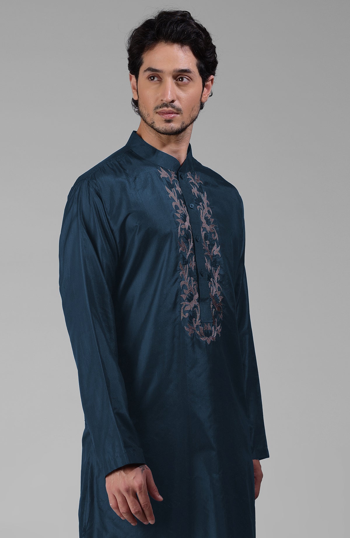 Teal silk kurta with floral embroidered placket detail.