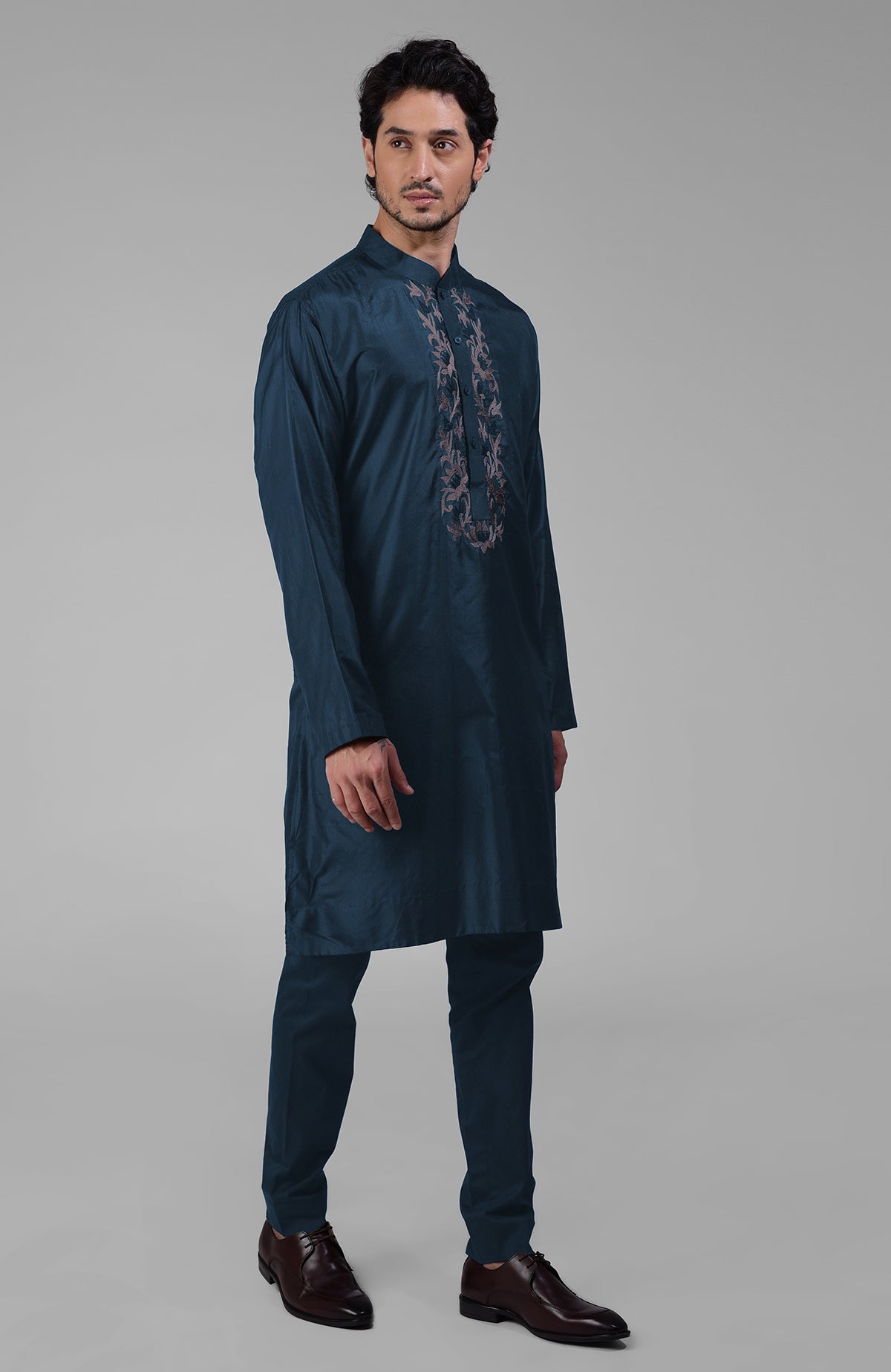 Teal silk kurta with floral embroidered placket detail.