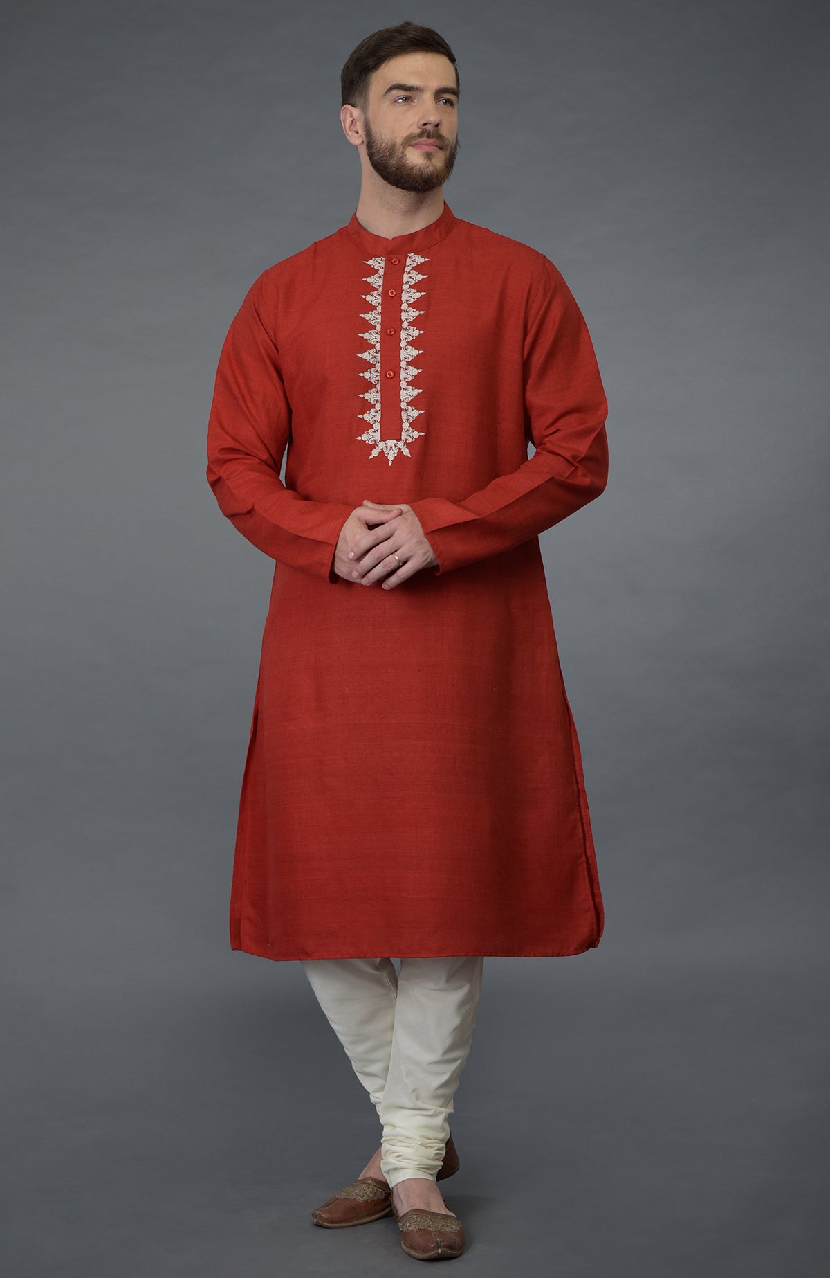Red pure silk kurta with floral embroidered placket and ivory churidar.