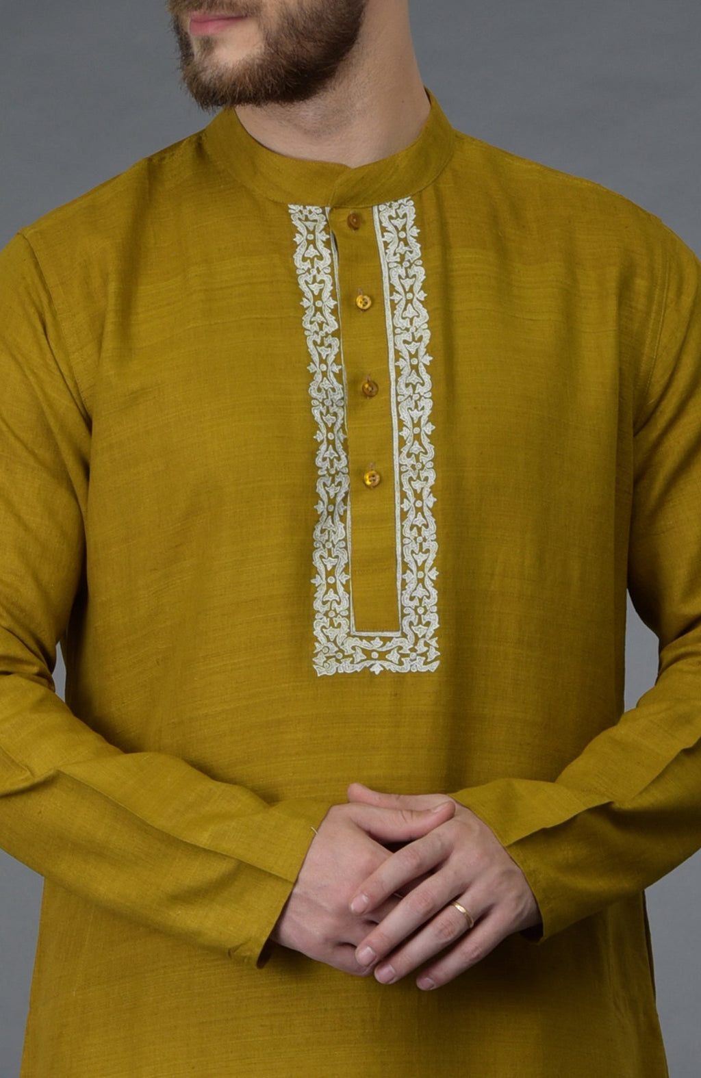 Mustard pure silk kurta with white embroidered placket and gold buttons.