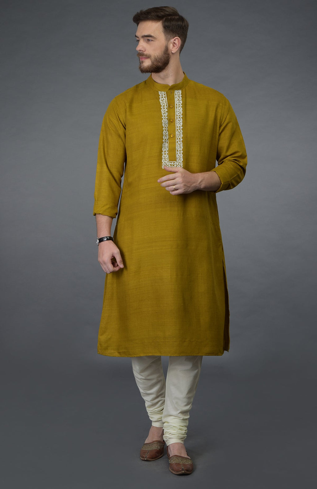 Mustard pure silk kurta with embroidered placket detail, ivory churidar, and brown juttis.