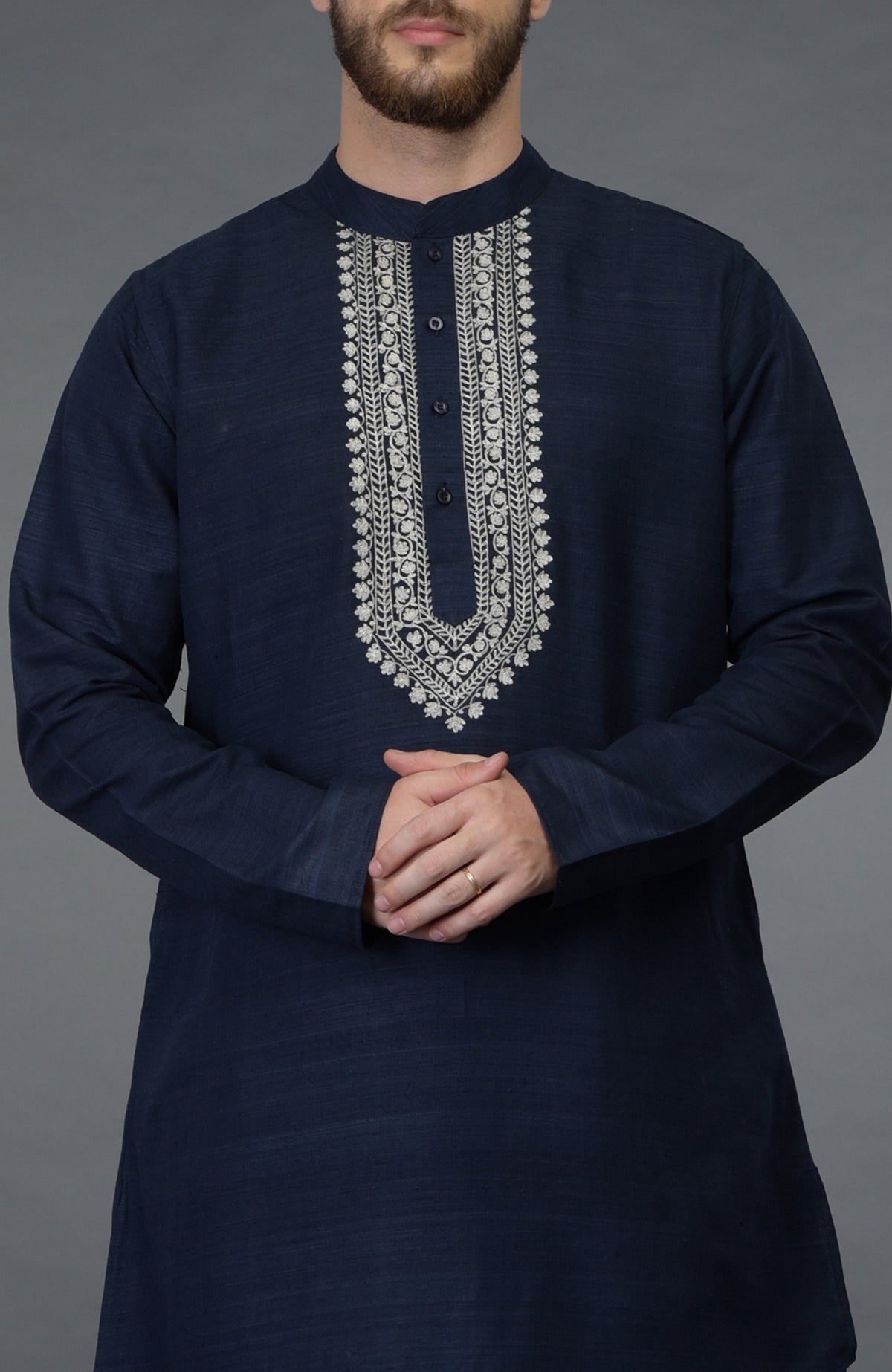 Navy blue asymmetric kurta with silver tilla embroidery and a buttoned placket.
