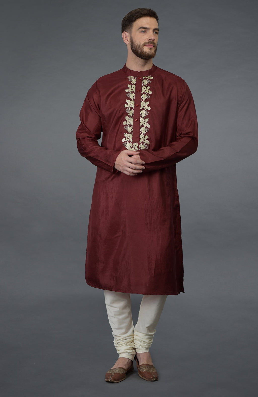 Burgundy silk kurta with gold tilla embroidery, paired with ivory churidar pants.