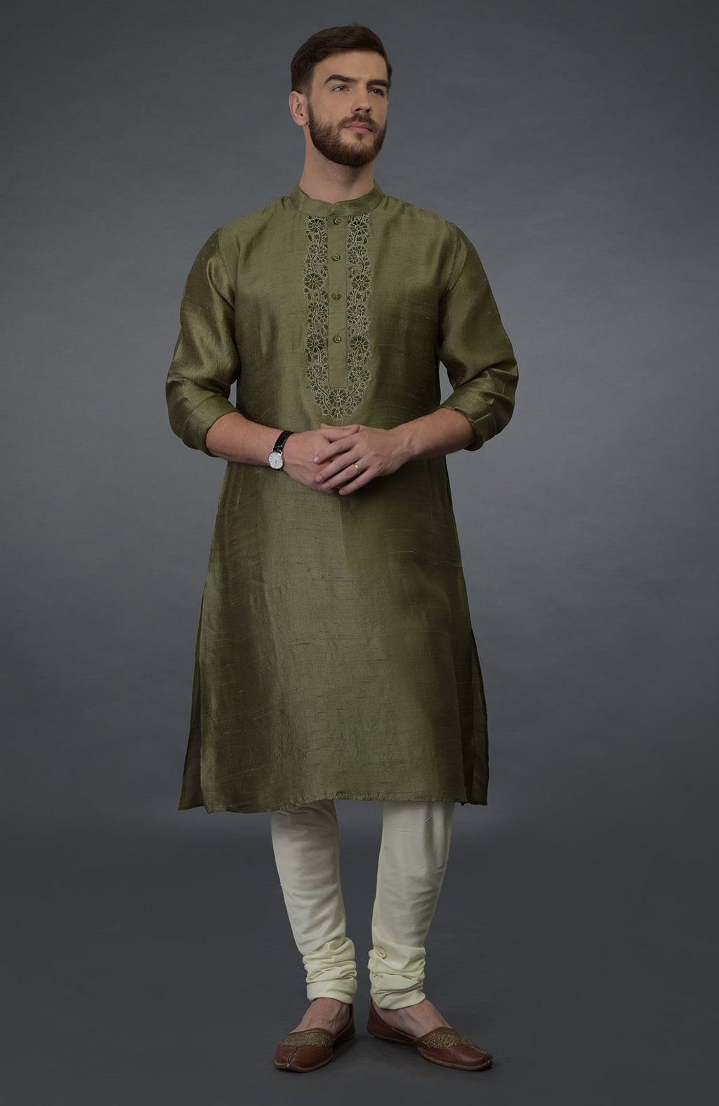 Olive green pure silk kurta with embroidered placket, ivory churidar, and brown juttis.