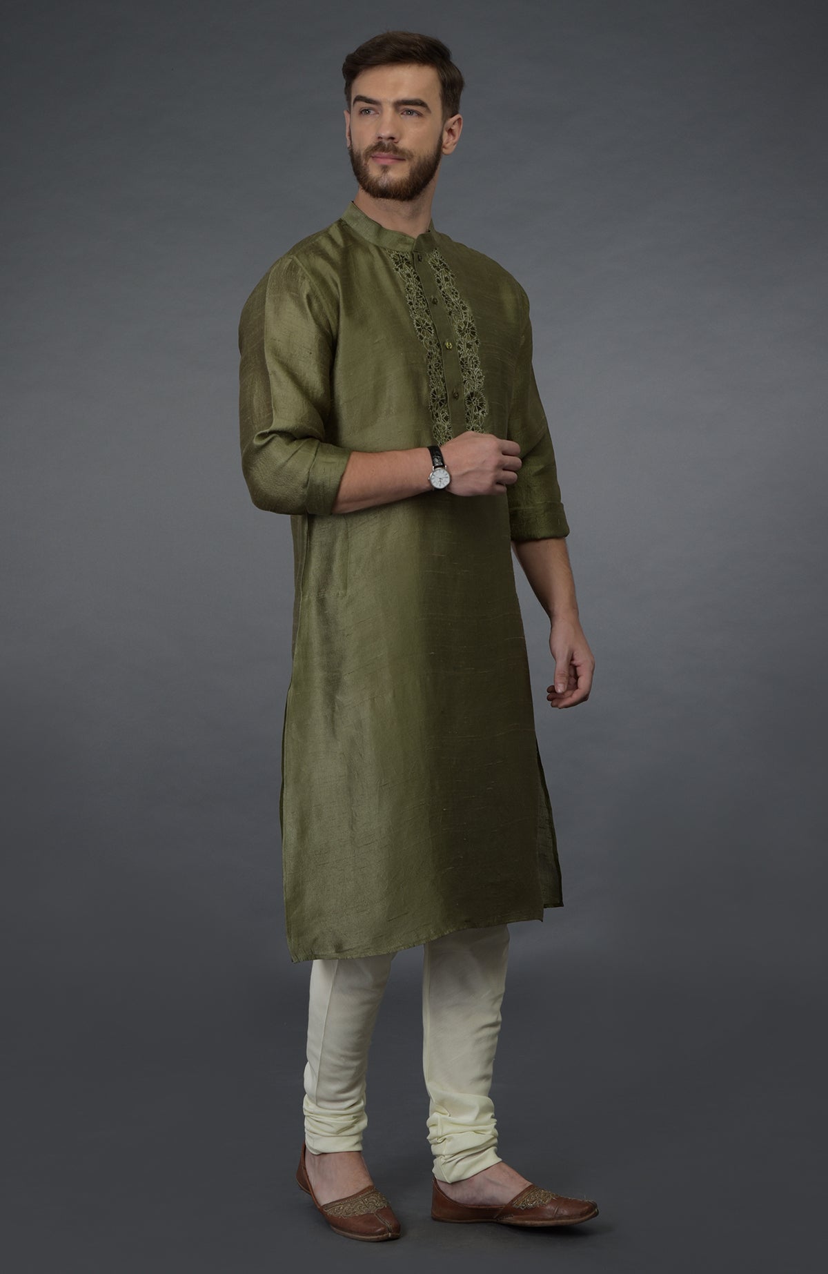 An olive green pure silk kurta set with intricate embroidery on the placket.