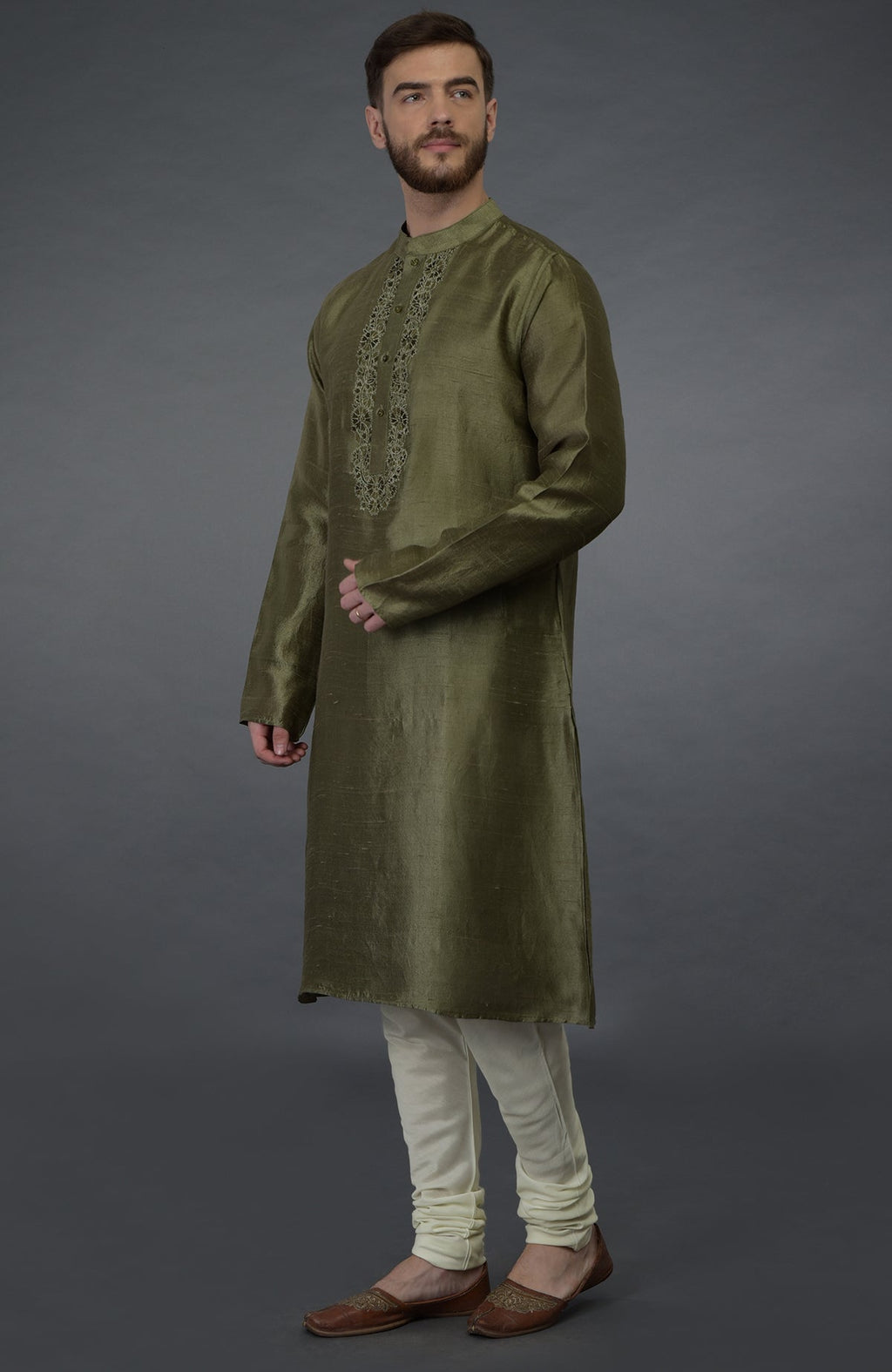 Olive green pure silk kurta with embroidered placket detail, paired with ivory churidars.