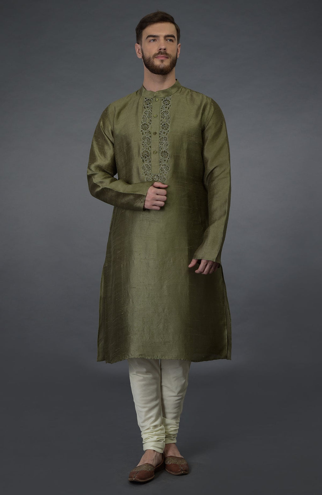 An olive green pure silk kurta set with floral embroidery on the placket.