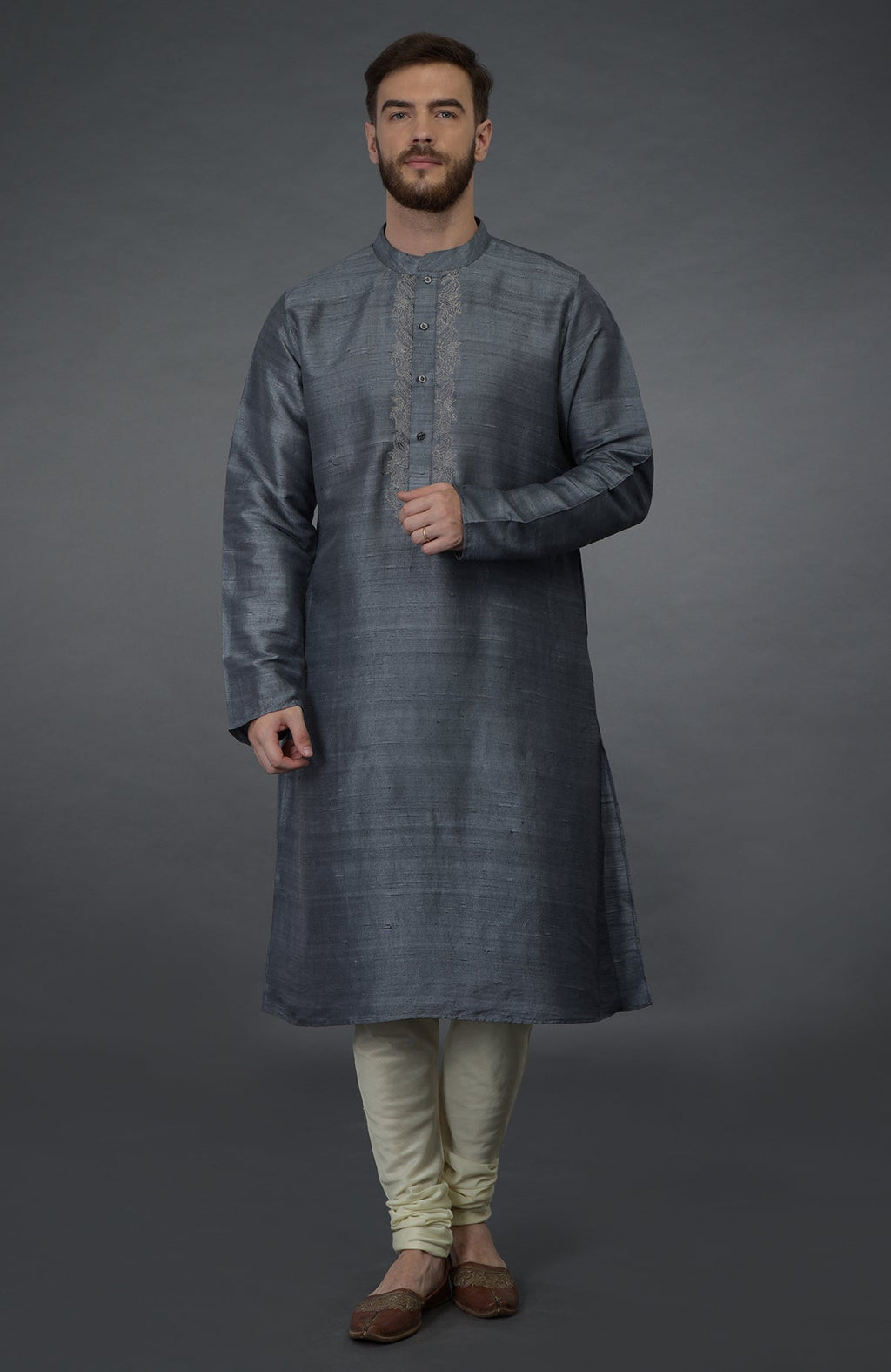 Grey pure silk kurta with embroidered placket detail, paired with ivory churidar and juttis.