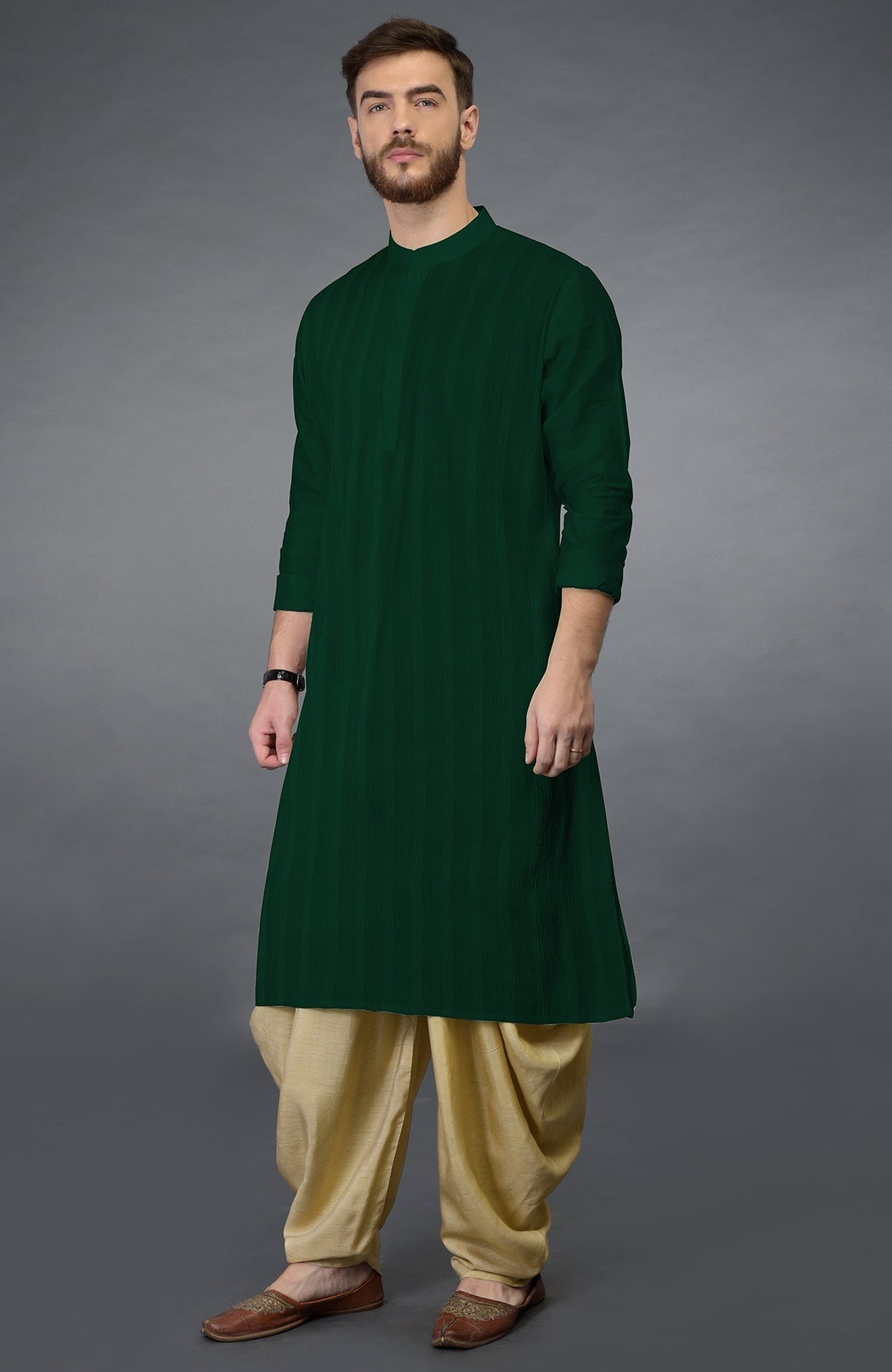 Bottle green kurta with pintuck stitching and beige gold dhoti salwar pants.