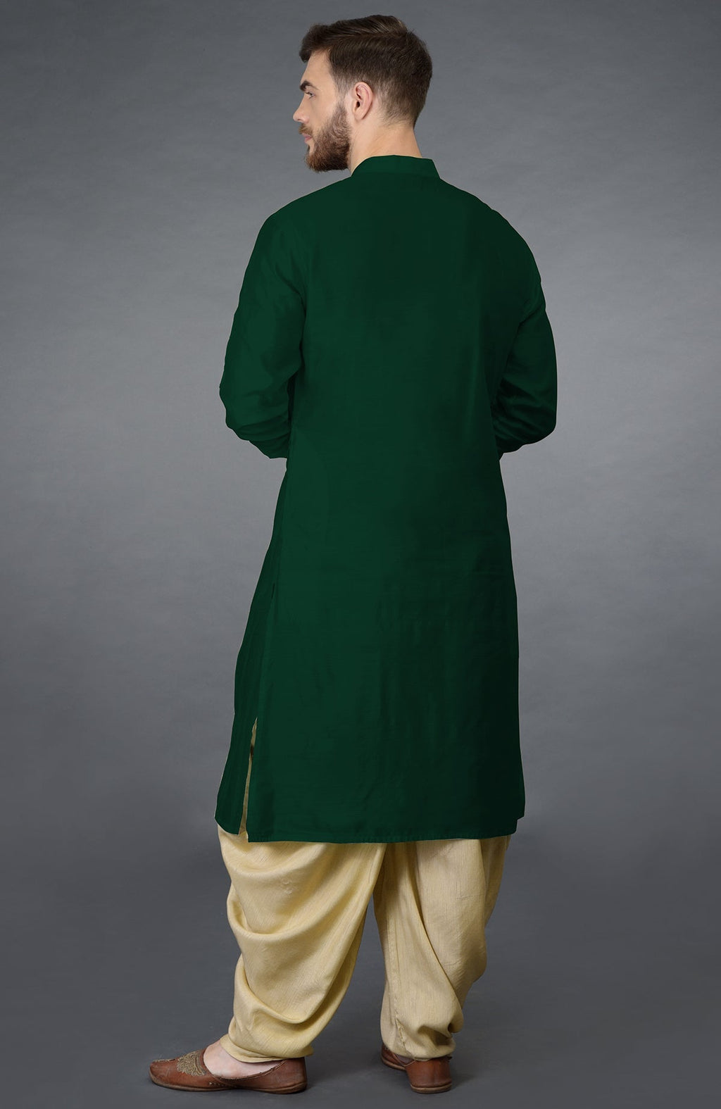 Bottle green kurta with pintuck stitch and long sleeves paired with beige gold dhoti salwar pants.