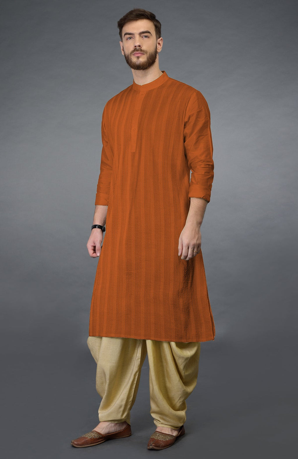 Gold flame pintuck kurta with long sleeves and beige gold dhoti salwar pants.