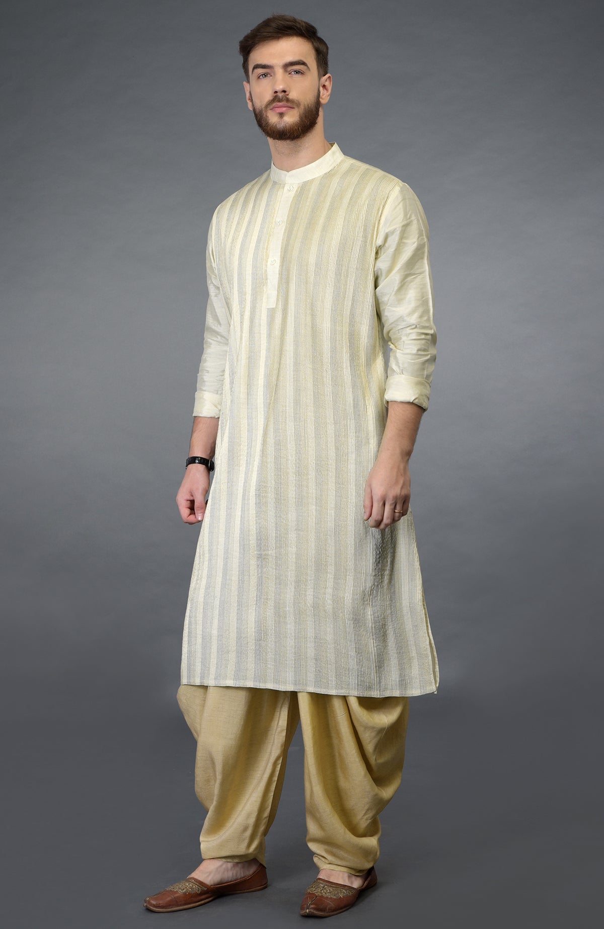 Cream pintuck pure silk kurta set with a striped kurta and beige gold dhoti pants.