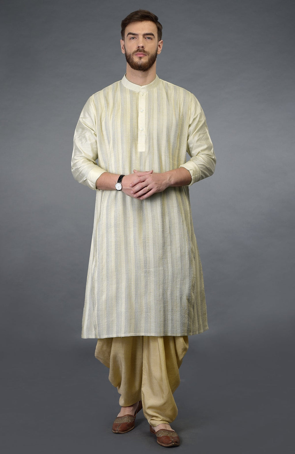A man models a cream pintuck pure silk kurta set with a striped pattern.