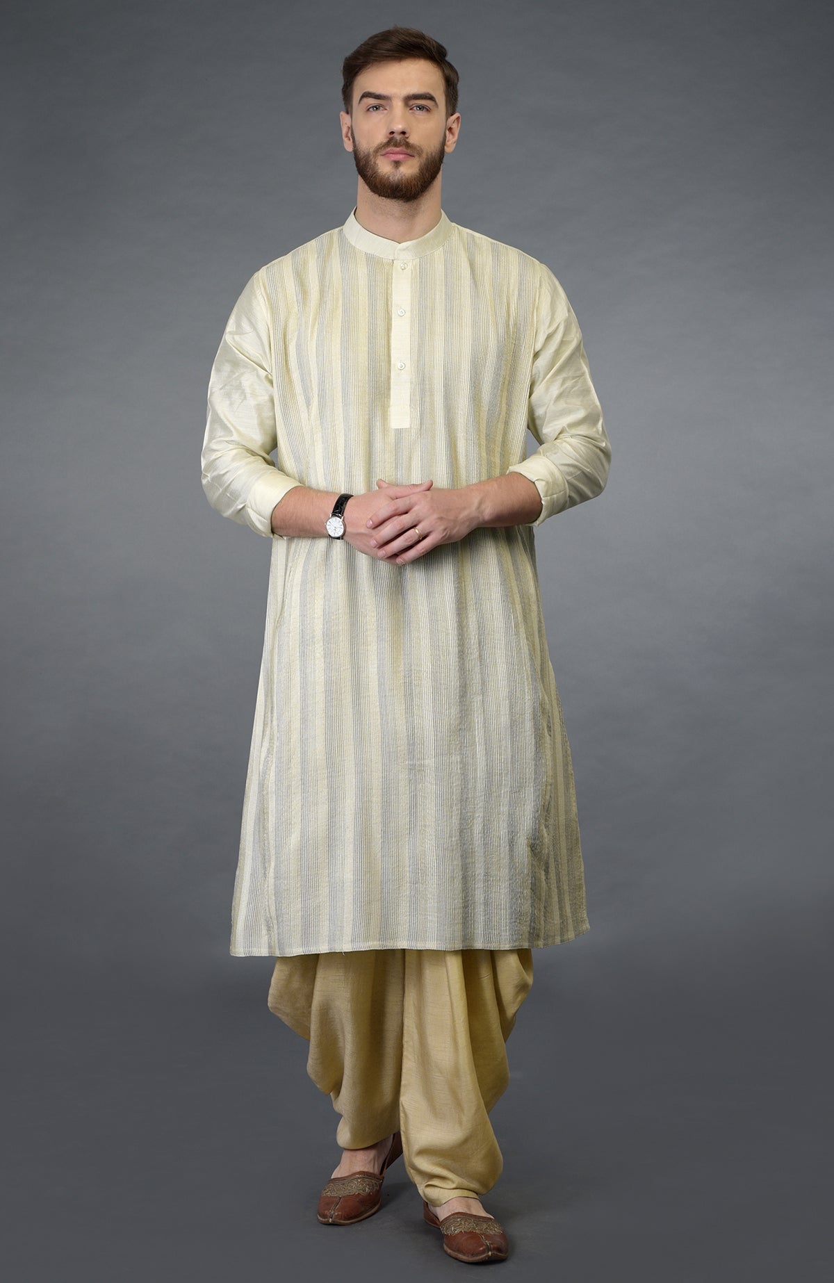 A man models a cream pintuck pure silk kurta set with a striped pattern.