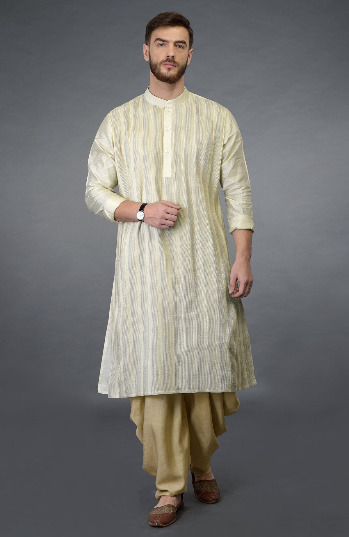 Bottle green kurta with pintuck stitching and beige gold dhoti salwar pants.