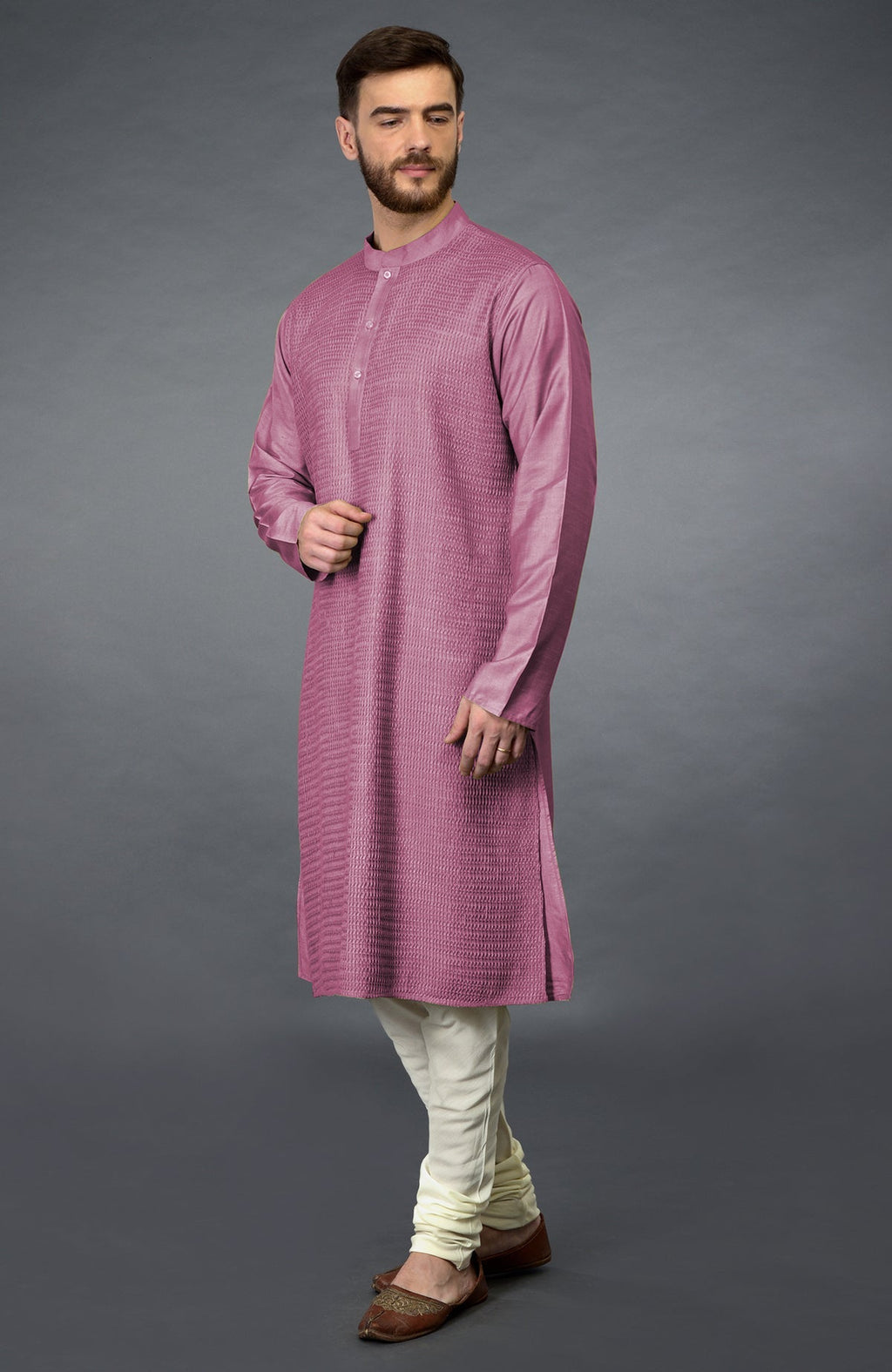 Wine kurta with pintuck detail, paired with ivory churidar and brown juttis.