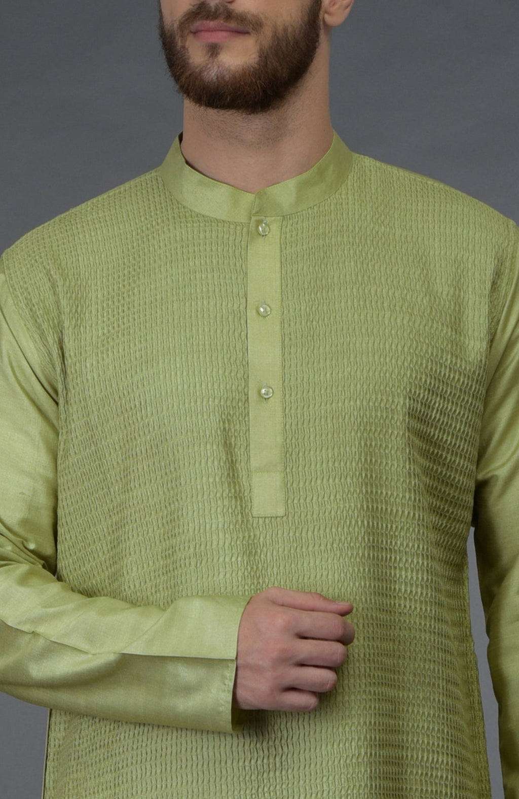 Pista green pintuck silk kurta with a band collar and buttoned placket.
