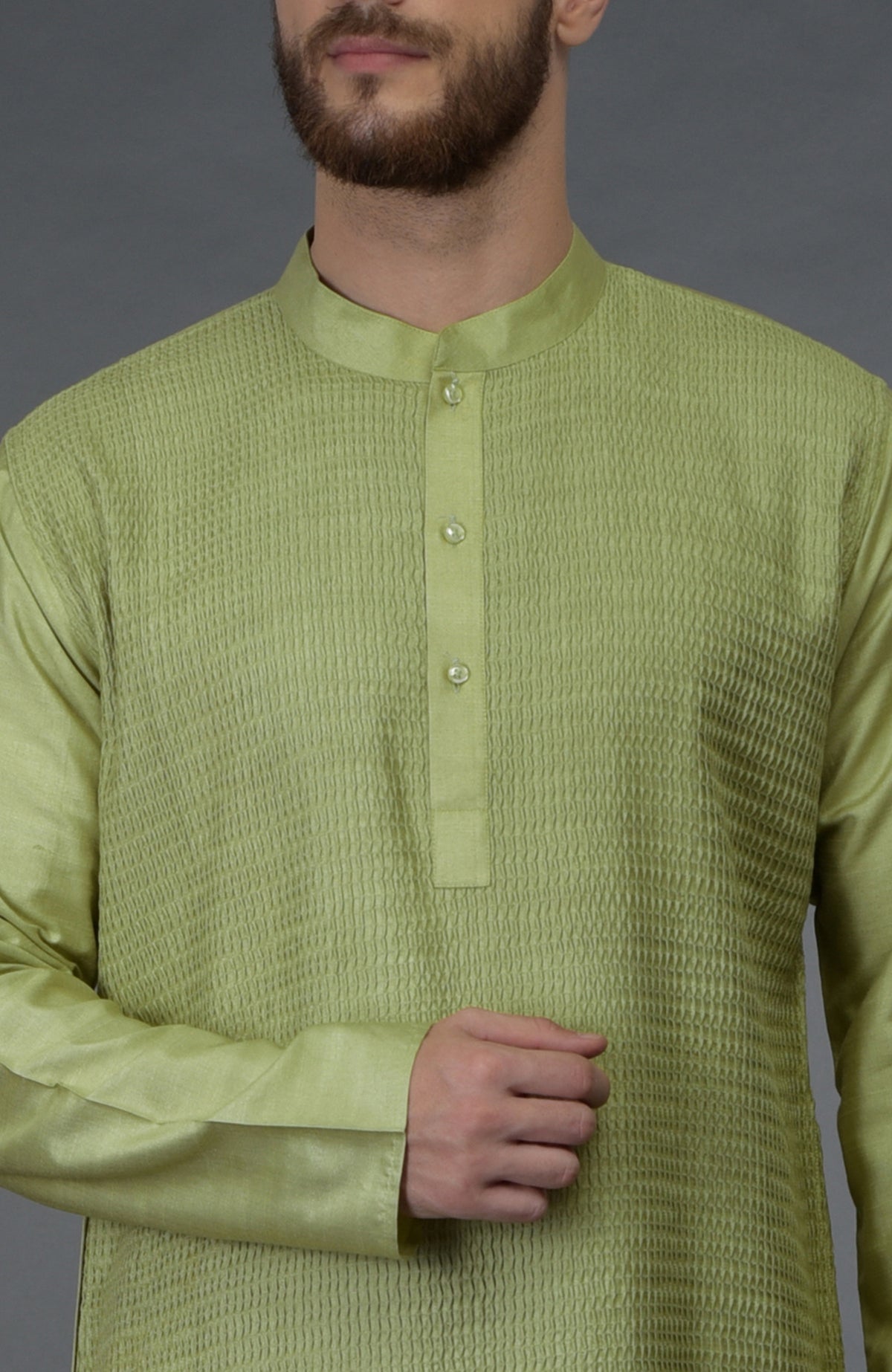Pista green pintuck silk kurta with a band collar and buttoned placket.