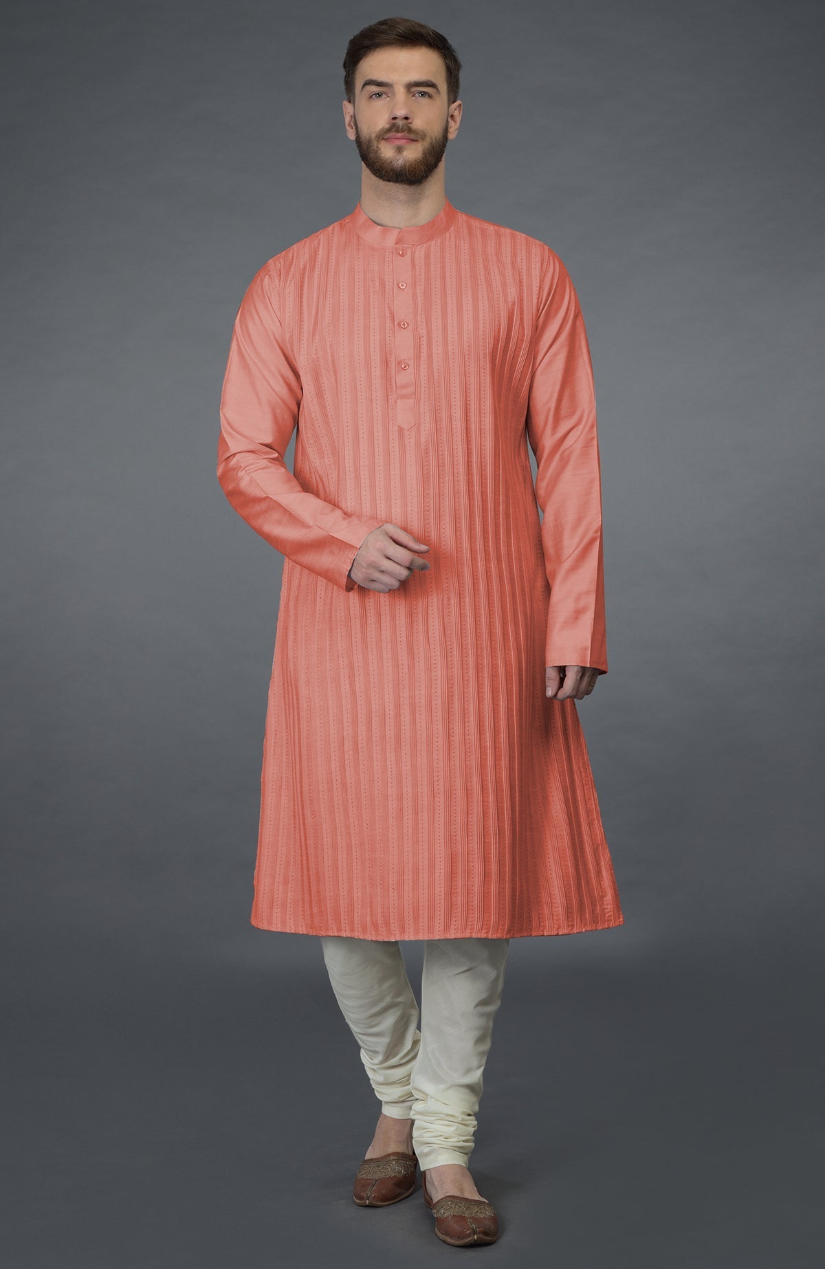Terracotta kurta with pintuck and Kantha hand embroidery, paired with ivory churidars.