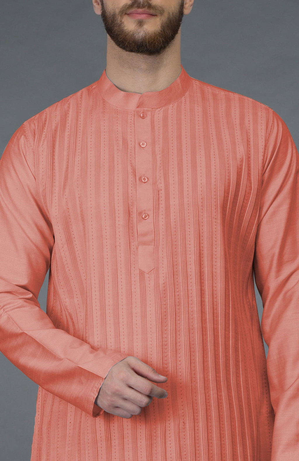 A man models a terracotta pintuck and kantha hand-embroidered kurta.