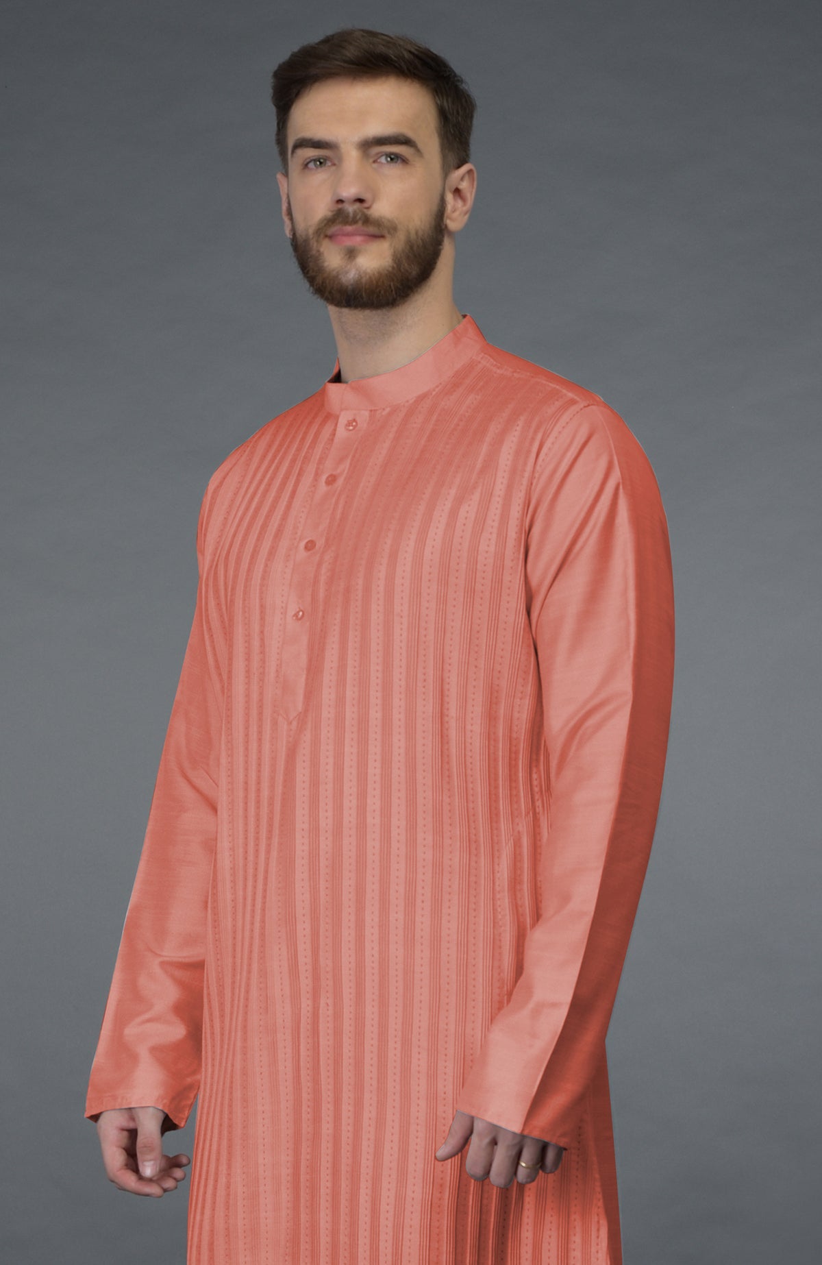 A man wears a terracotta kurta with pintuck and kantha hand embroidery.
