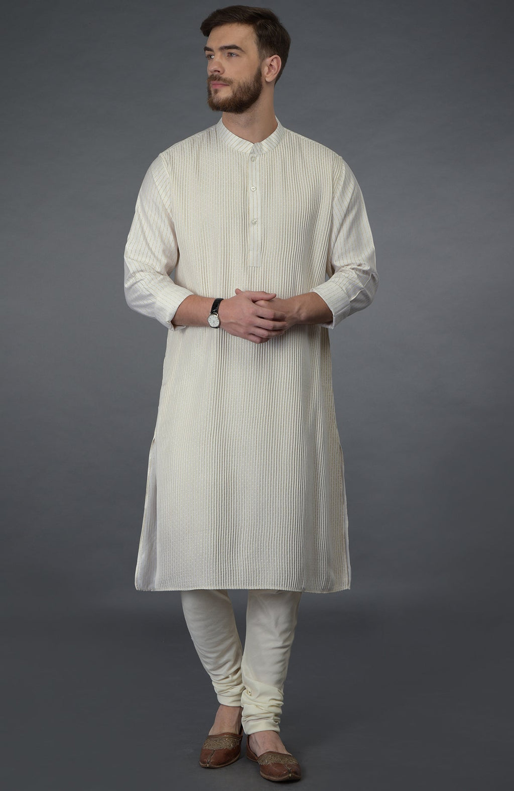 An ivory silk kurta with pintuck detail is worn by a man with a beard.