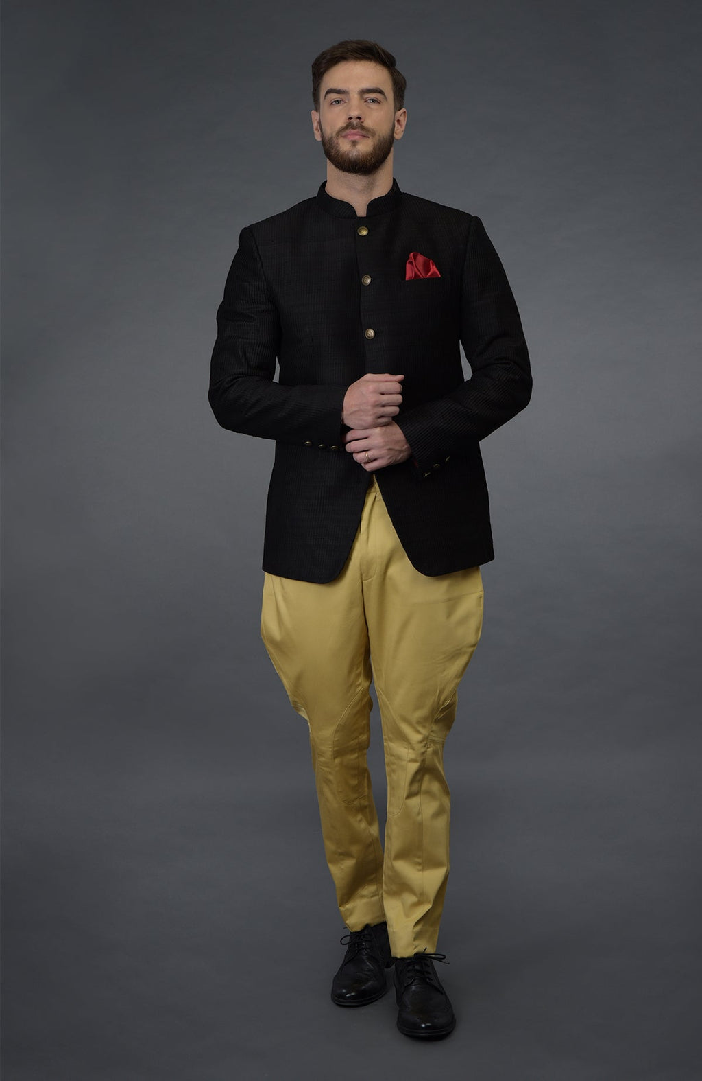 Black pintuck bandhgala jacket set with camel beige breeches and black shoes.