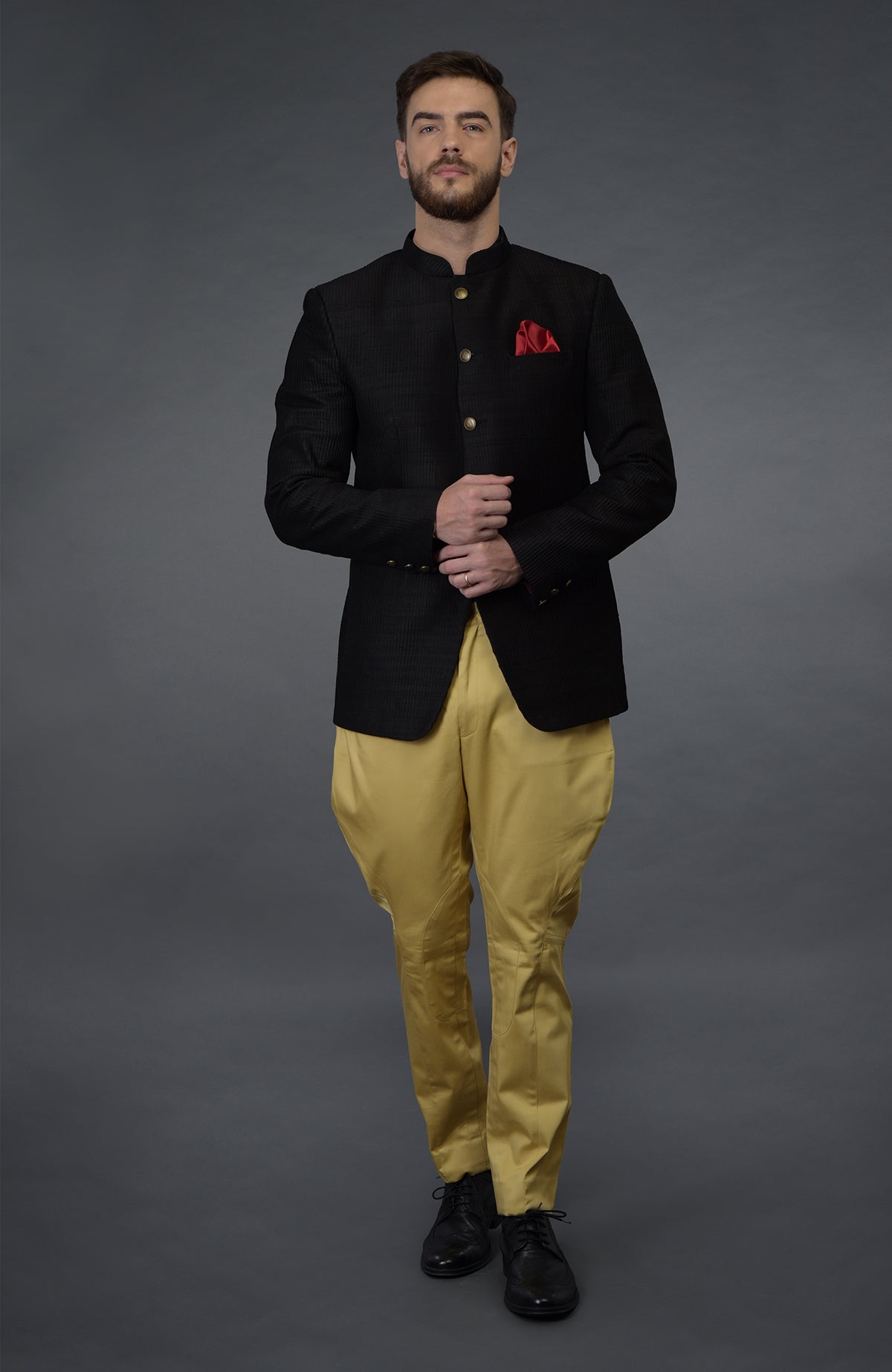 Black pintuck bandhgala jacket set with camel beige breeches and black shoes.