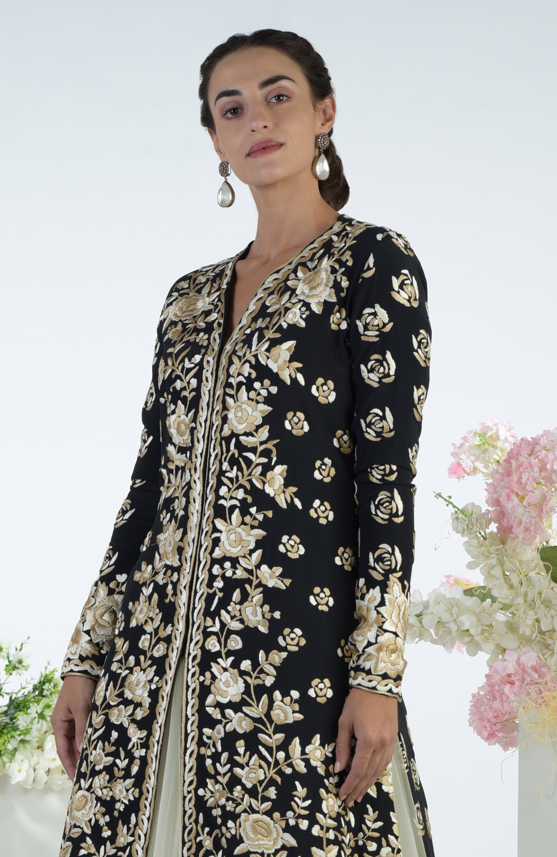 Black jacket with ivory and beige floral Parsi Gara embroidery paired with a full volume tulle skirt
