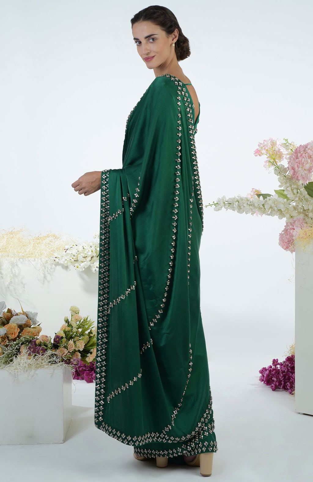 Emerald green crystal hand-embroidered saree and blouse on a model.