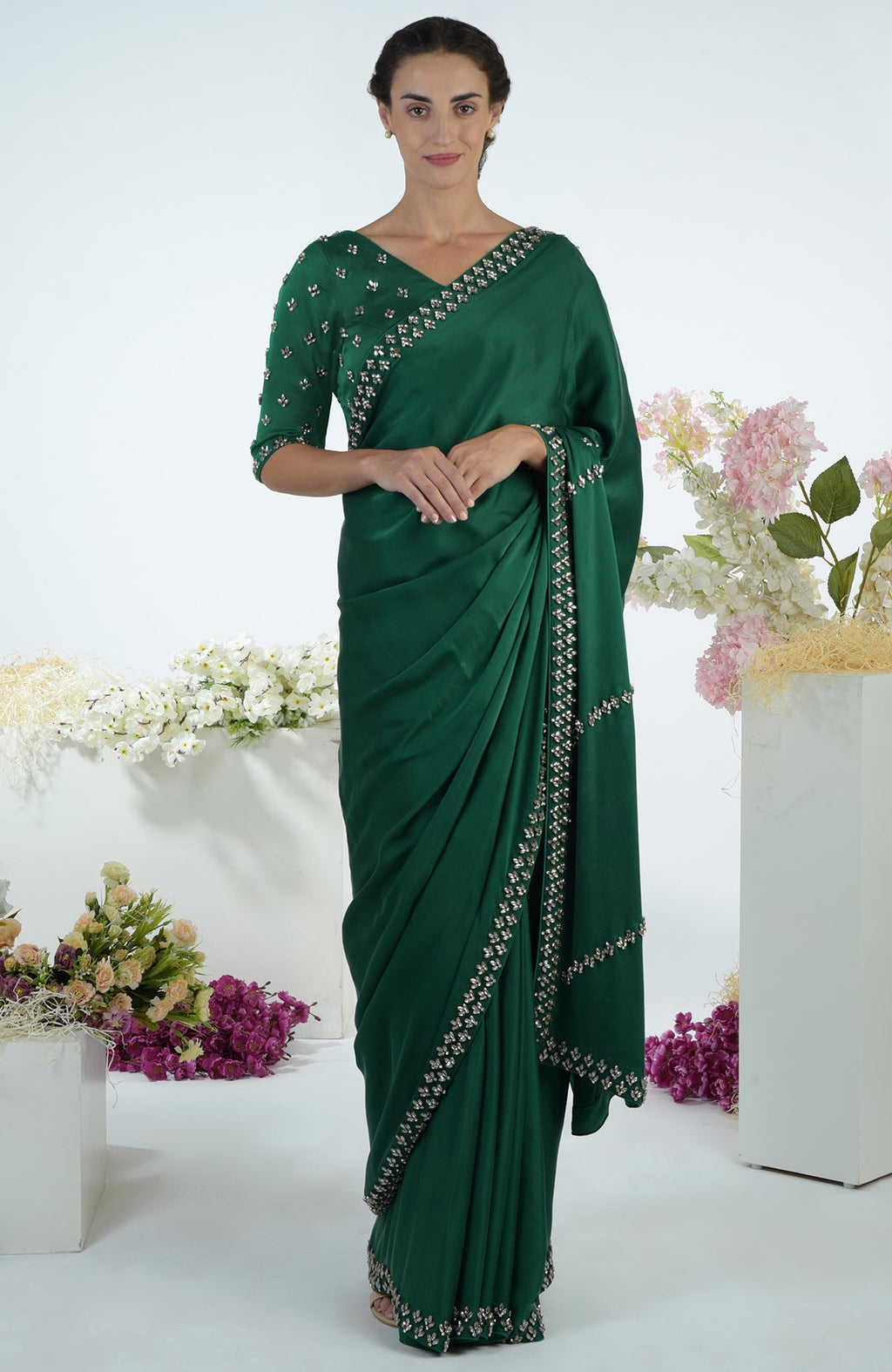 Emerald green crystal hand-embroidered saree and blouse on a model.