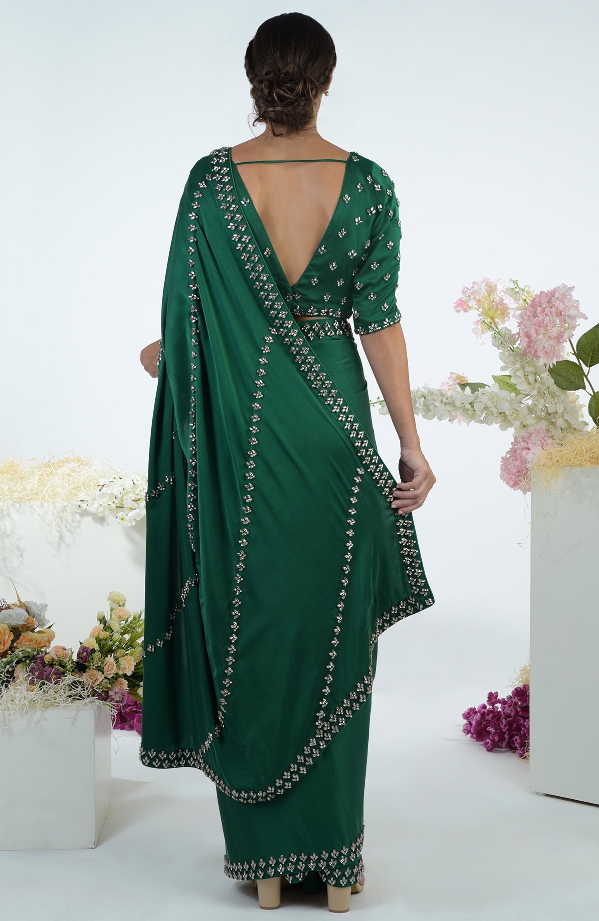 Emerald green crystal hand-embroidered saree and blouse, viewed from the back.