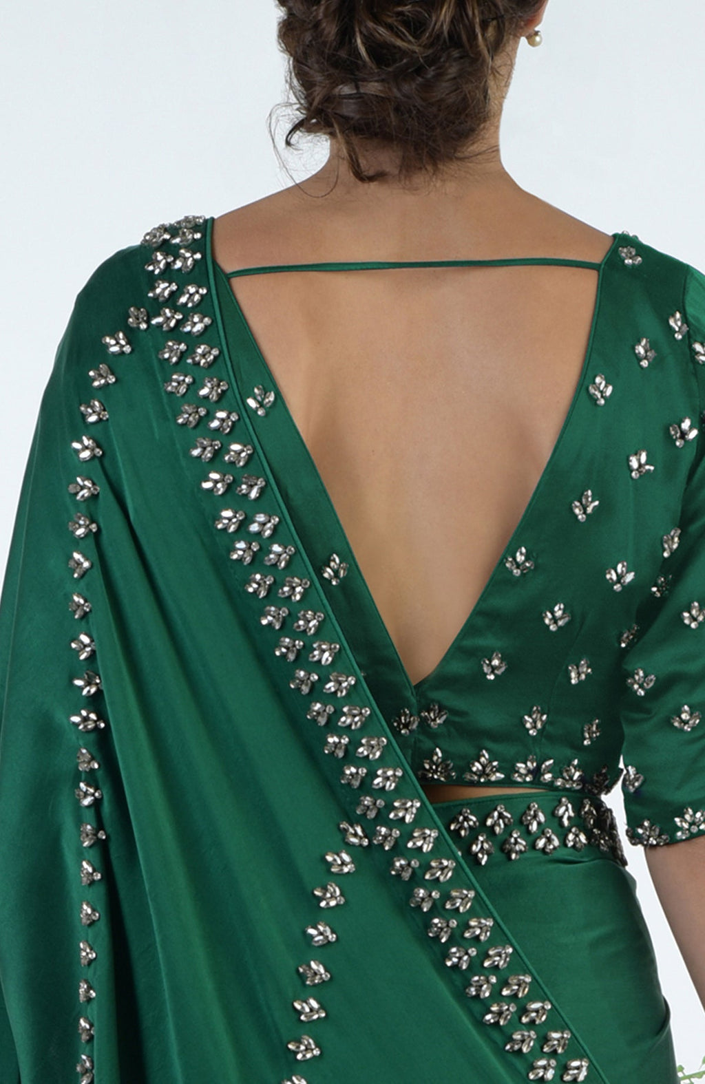 Emerald green crystal hand-embroidered saree and blouse with a deep V-back.