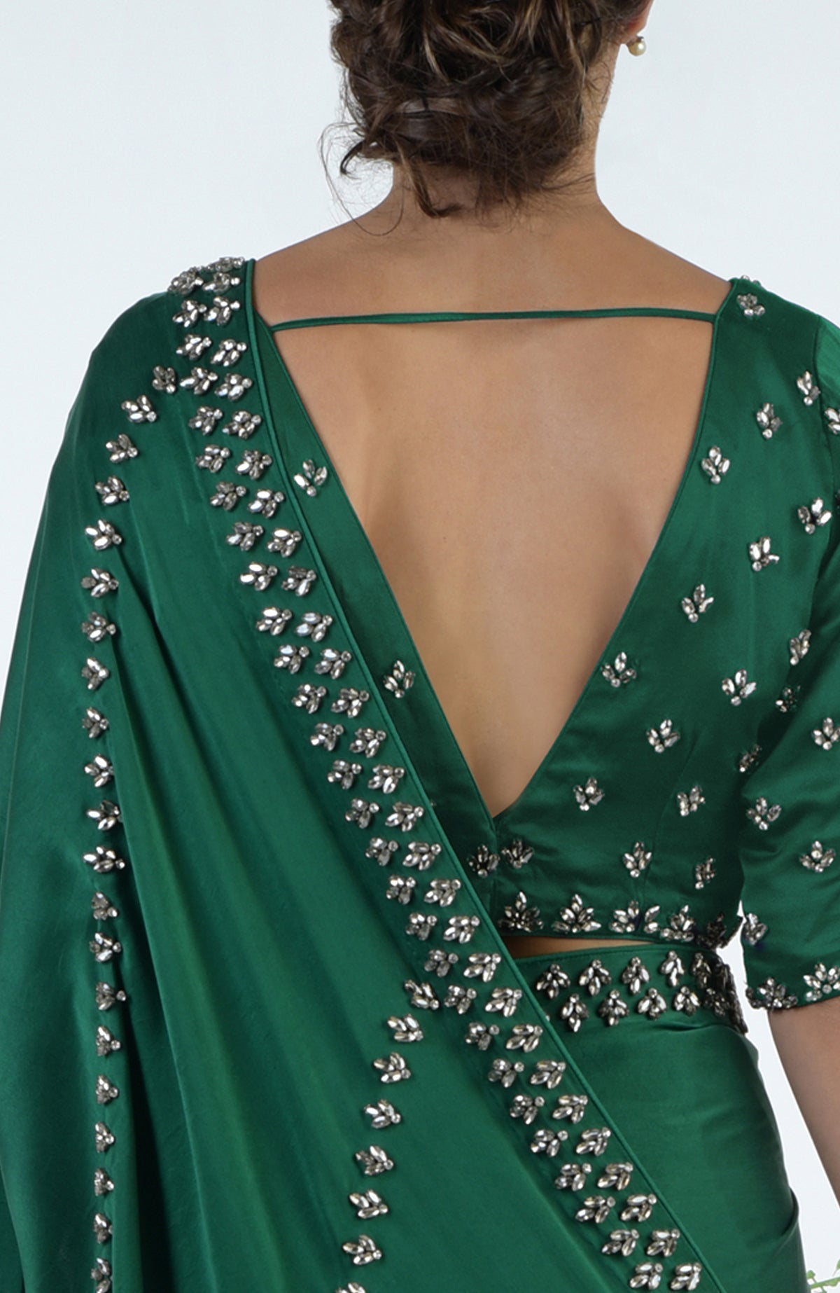 Emerald green crystal hand-embroidered saree and blouse with a deep V-back.