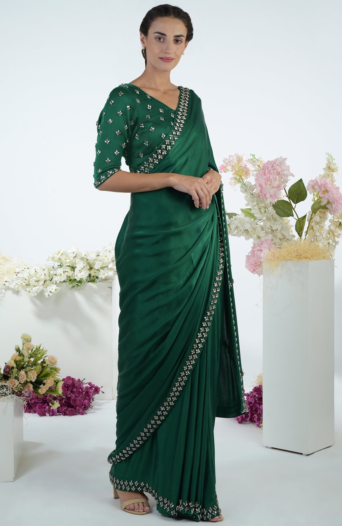 Emerald green crystal hand-embroidered saree and blouse on a model.